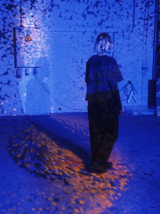 A portrait dissolving into a cloud of generative particles